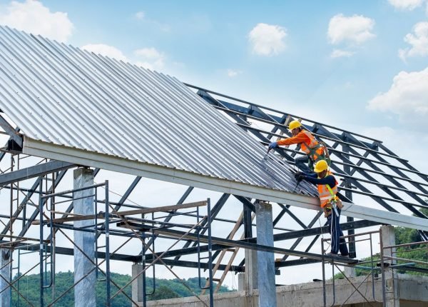 Working at height equipment.Construction worker wearing safety harness are working on the roof house in construction site.